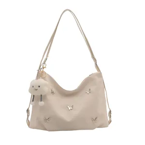 Cream white shoulder bag with silver butterflies and a plush cloud charm detail