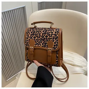 Detail of trendy small leopard print patchwork backpack with vintage buckle and handle