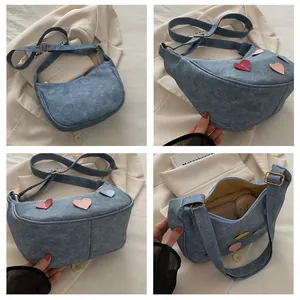 Detail shots of blue denim crescent bag with colorful heart patches and interior space