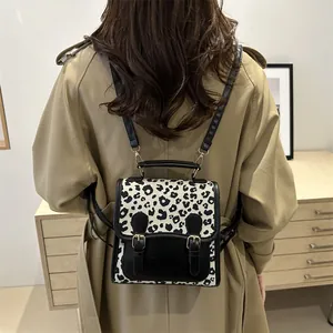 Chic leopard print mini backpack for women with black faux leather and metal buckles