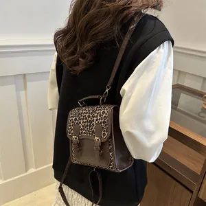 Chic leopard print small backpack for women in dark brown PU leather on a model