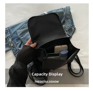 Internal capacity display of black backpack with red heart pattern showing daily items