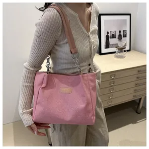 Pink minimalist canvas tote bag with leather strap and metal chain details
