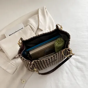 Top view of houndstooth tote bag interior showing laptop and umbrella storage capacity