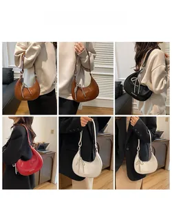 Detail view of crescent shoulder bags in four colors with pearl bow charms and smooth finish