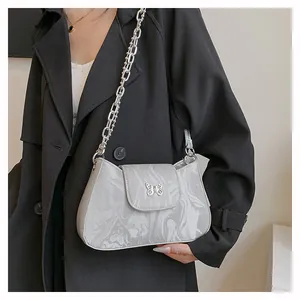 Detail of grey marble pattern underarm bag with silver butterfly buckle and chain strap