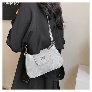 Detail of marble pattern underarm bag featuring a butterfly buckle and metal ring