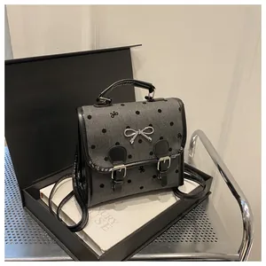Detailed view of a retro polka dot backpack in a luxury gift box setting