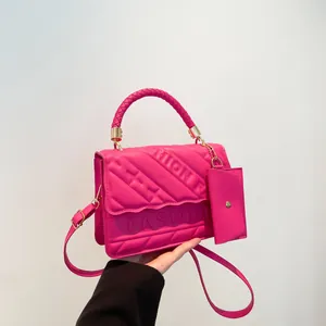 Fuchsia quilted crossbody handbag with FASHION lettering and detachable mini pouch