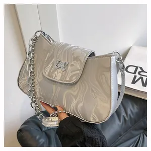 Close-up of silver marble texture underarm bag with butterfly buckle and metal chain