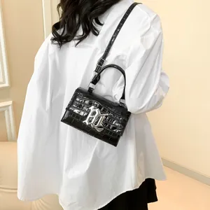 Damen Handtasche in Schwarz mit Krokodilmuster, silbernem B-Logo und verstellbarem Riemen