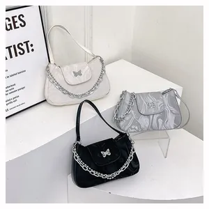 Detailed display of underarm bags in white, gray, and black with marble texture