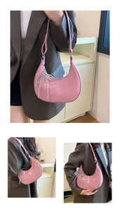Pink crescent bag detail with glossy finish and silver beaded bow charm accessory