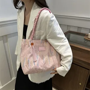 Pink quilted tote bag for women with colorful embroidery and woven shoulder strap