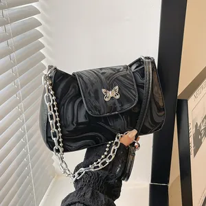 Chic black marble-patterned underarm bag with silver butterfly clasp and chain strap