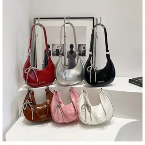 Detailed display of semi-circular crossbody bags with metallic bow tassels in six colors
