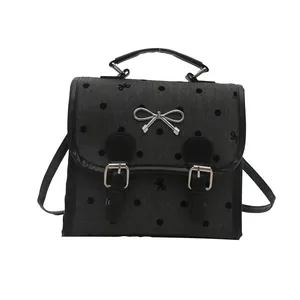 Fashionable dark grey herringbone handbag with black polka dots and silver bow charm