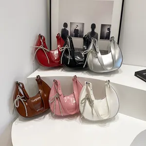 Minimalist crescent crossbody bags in six vibrant colors with pearl bow charms