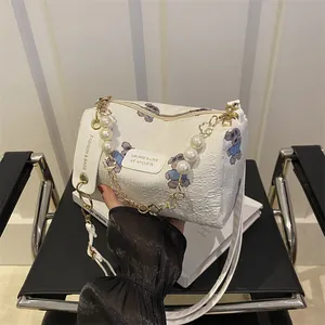 White textured cylindrical crossbody bag with cute purple bear print and pearl chain
