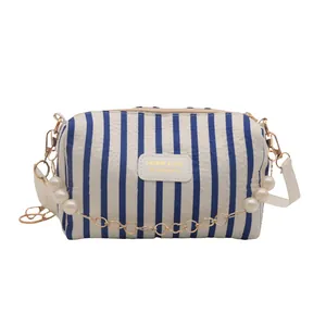 Blue and white striped pillow bag with pearl metal chain and adjustable strap
