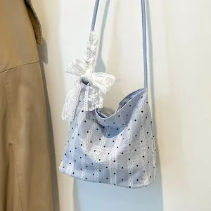 Chic light blue polka dot underarm bucket bag with white lace stripes and bow detail