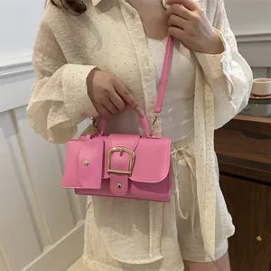 Stylish bright pink square handbag with matching mini pouch and adjustable shoulder strap