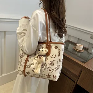 Large white graffiti tote bag with brown straps and cute bear charm for women