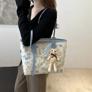 Fashionable creamy-white large tote bag with blue bear graffiti prints and bear charm