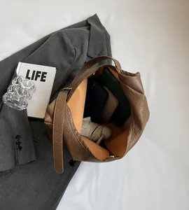 Brown pleated tote bag with large interior capacity for daily essentials and umbrella