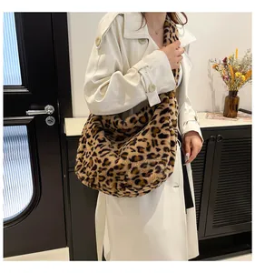Close-up of plush leopard print tote bag with soft faux fur texture and long shoulder strap