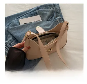 Detail showing spacious interior compartment and inner zipper pocket of the beige hobo bag