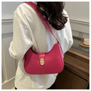 Detail of rose red crescent hobo bag with a gold metal clasp and smooth PU leather finish