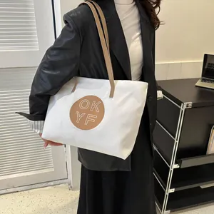 Minimalist white canvas tote bag with brown leather straps and OKYF logo patch for women