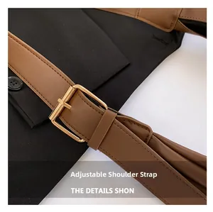 Close-up of brown leather adjustable shoulder strap with refined gold metal buckle detail