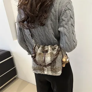 Winter plush checkered bucket bag with woven handle and cute monster charm on shoulder