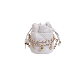Elegant white quilted bucket bag with golden heart charms and chain strap detail