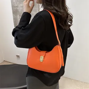 Chic orange faux leather crescent underarm bag with gold twist lock for women