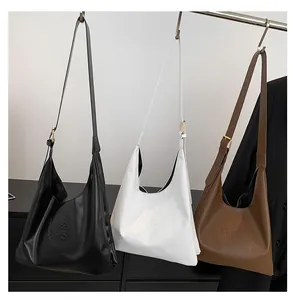 Detailed view of large leather tote bags in black white and brown with embossed logo