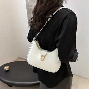 Chic white crescent shoulder bag with gold clasp and adjustable strap for women