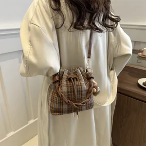 British style plaid wool bucket bag with leather handle and pompom charm for winter fashion