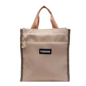 Chic beige waterproof insulated lunch bag with FASHION label and front zipper pocket