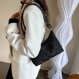 Classic black quilted shoulder bag for women with minimalist rhombic pattern design