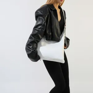 Detailed side view of white faux leather tote bag with embossed logo on shoulder strap