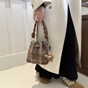 Chic retro plaid drawstring bucket bag with a plush bear charm for winter fashion