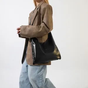 Detail of the high-quality black faux leather texture and embossed BAG lettering on the purse