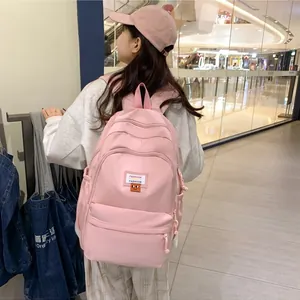 Zaino in nylon rosa con più strati di cerniere e icona a cartone animato per la scuola