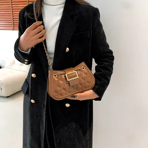 Brown quilted chain bag with gold metal clasp in a retro minimalist square crossbody style