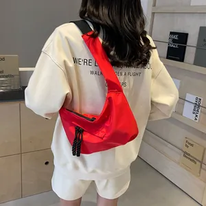 Red large capacity nylon crescent tote bag with wide black shoulder strap for women