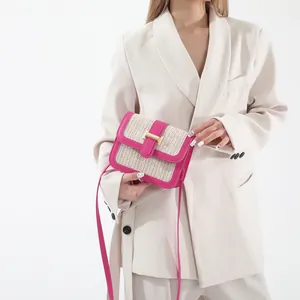 Detail of summer crossbody bag with contrast stitching and golden hardware buckle