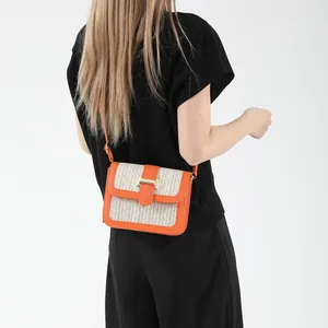 Retro contrast crossbody bag in orange and beige with metallic H-buckle on model